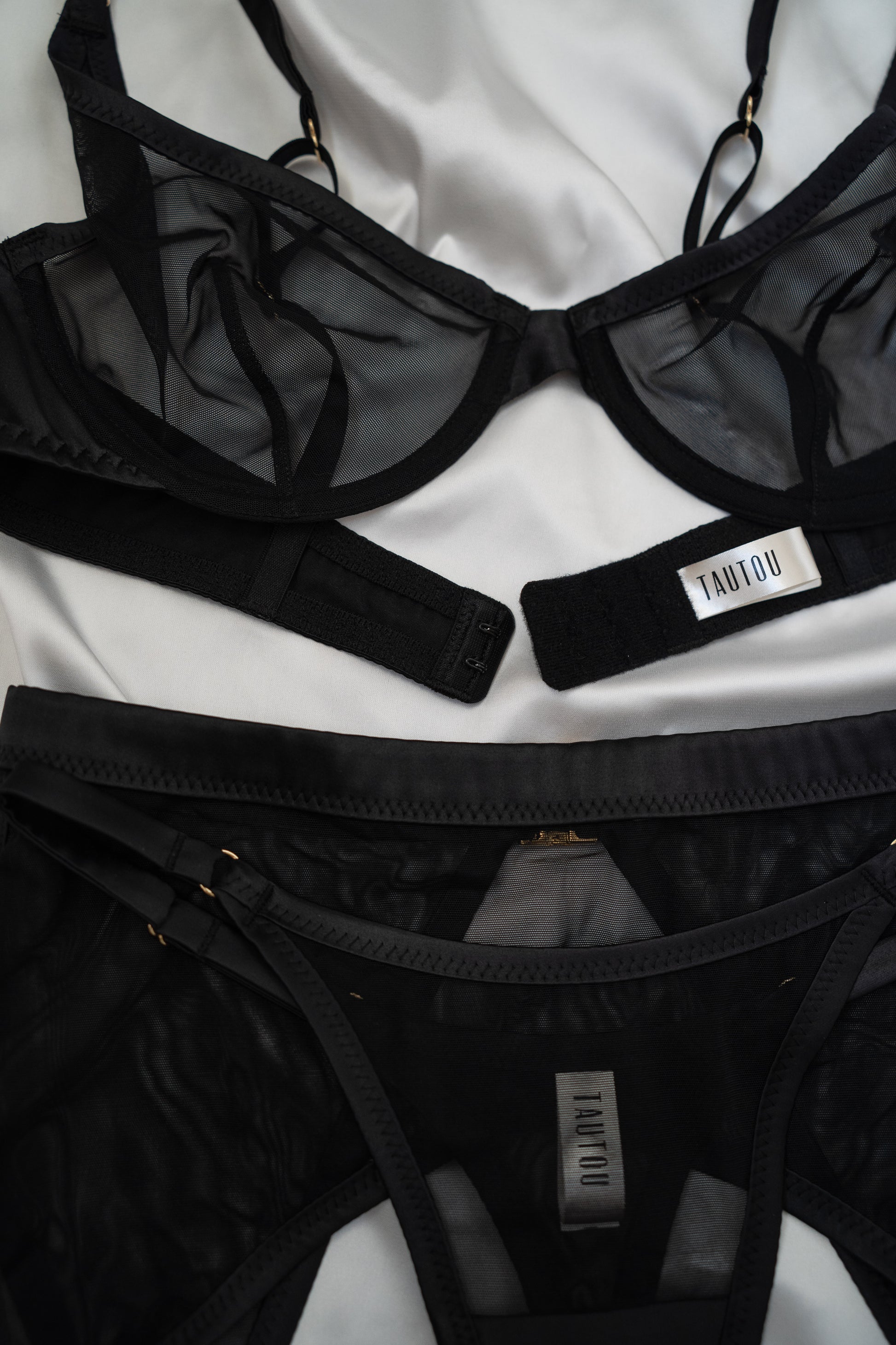 Black lingerie set with visible brand label on a white background