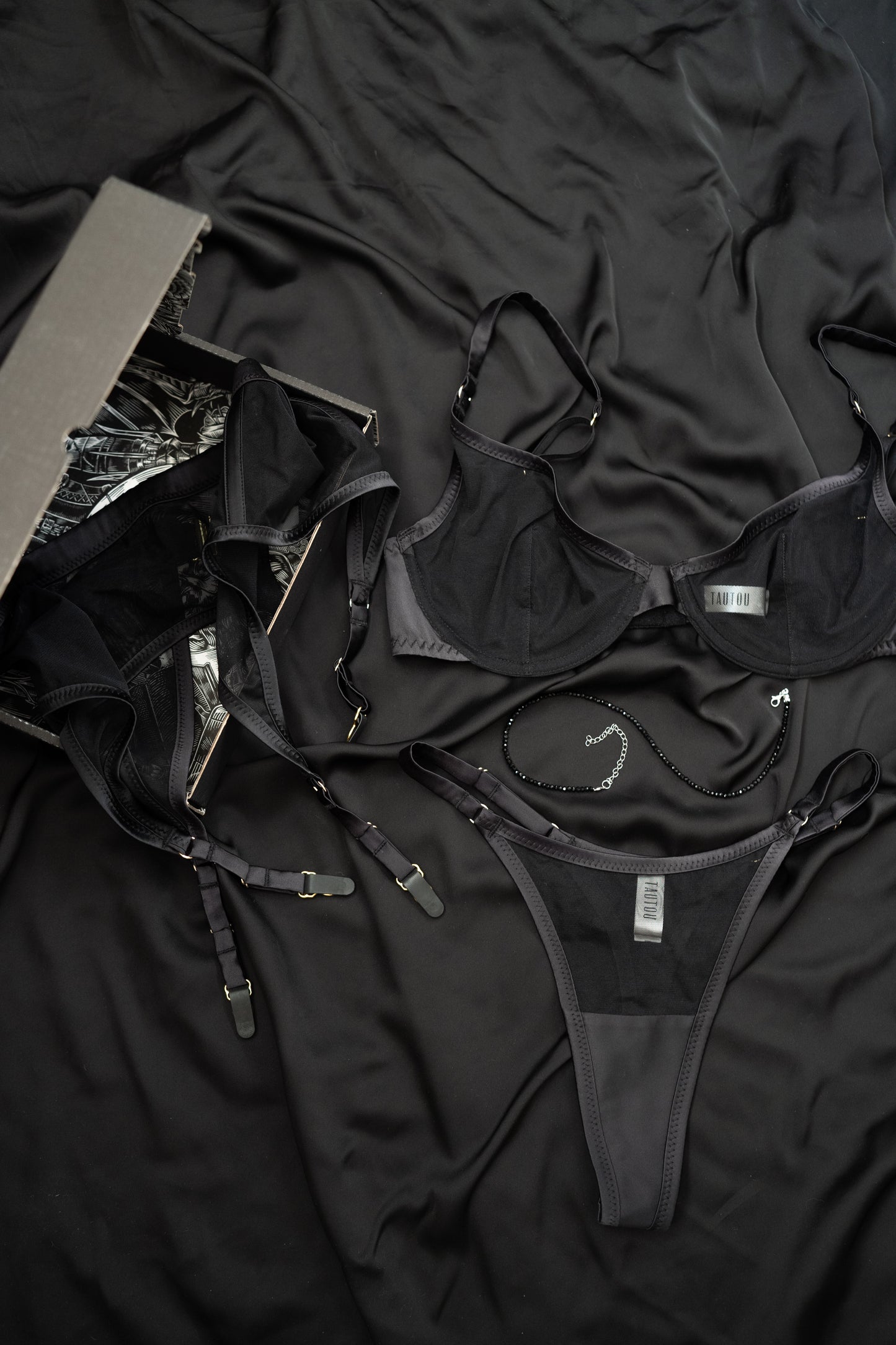 Black lingerie set on a dark fabric background