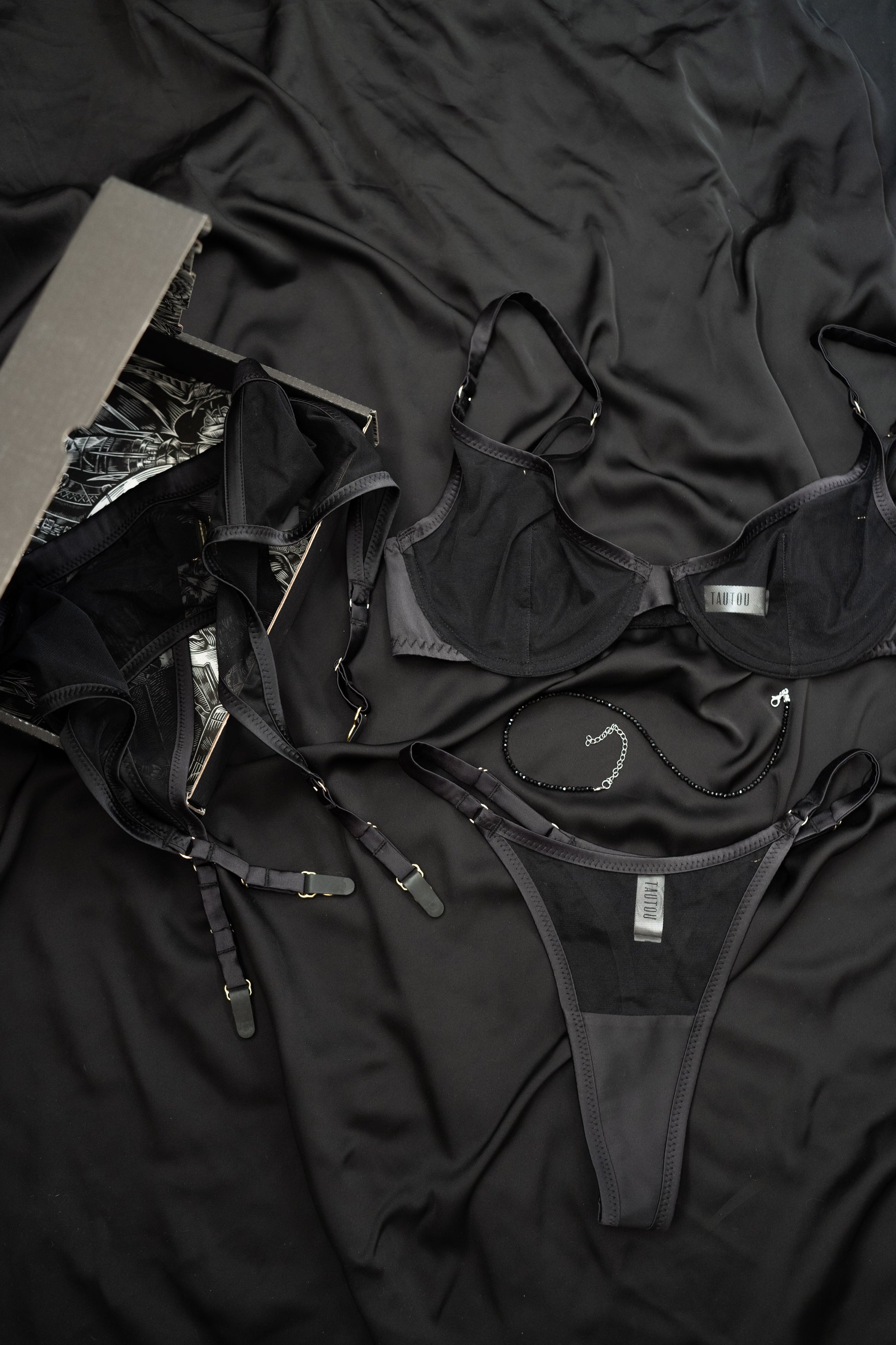 Black lingerie set on a dark fabric background