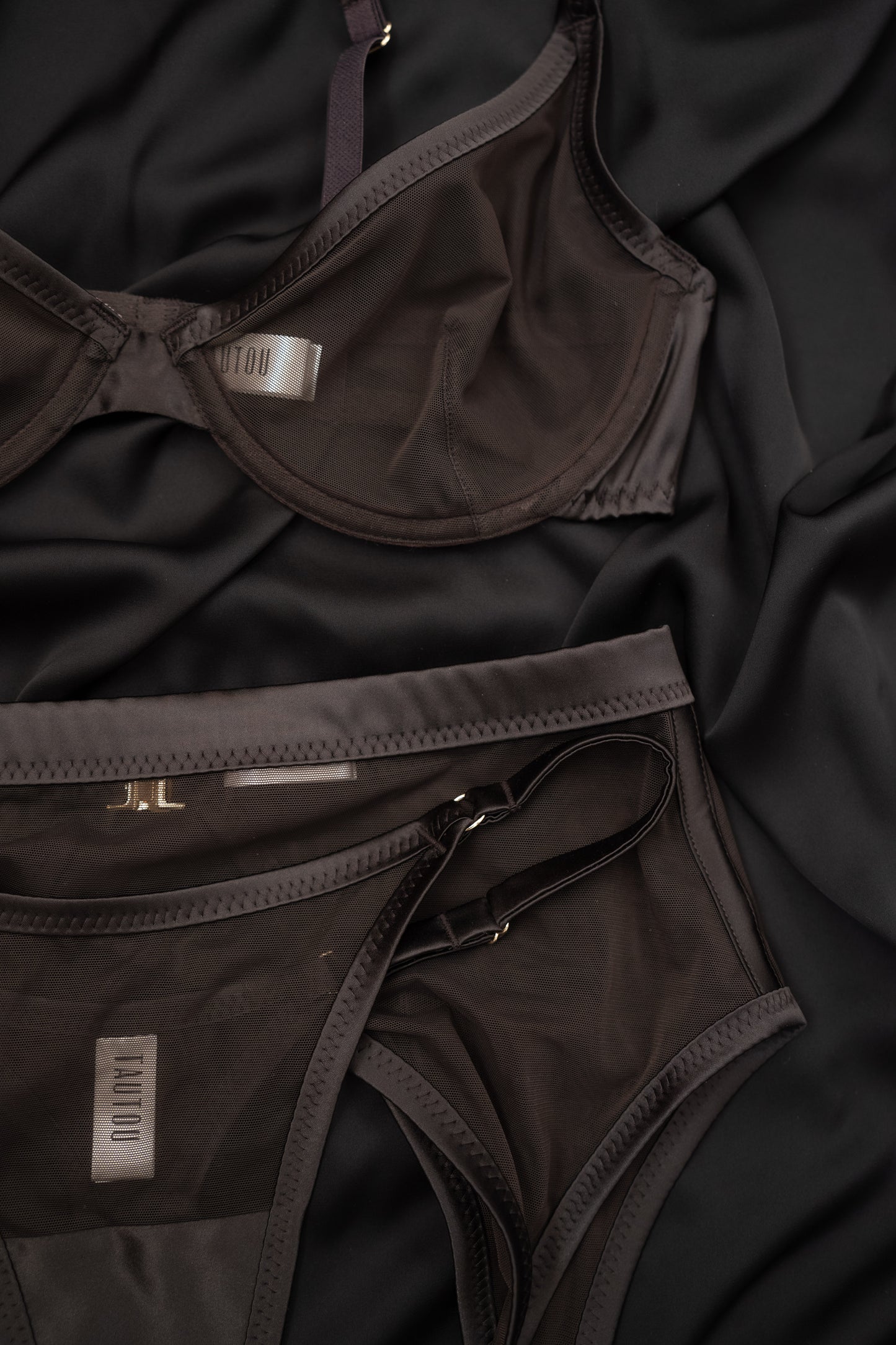 Brown lingerie Tate Chocolate set on a dark fabric background