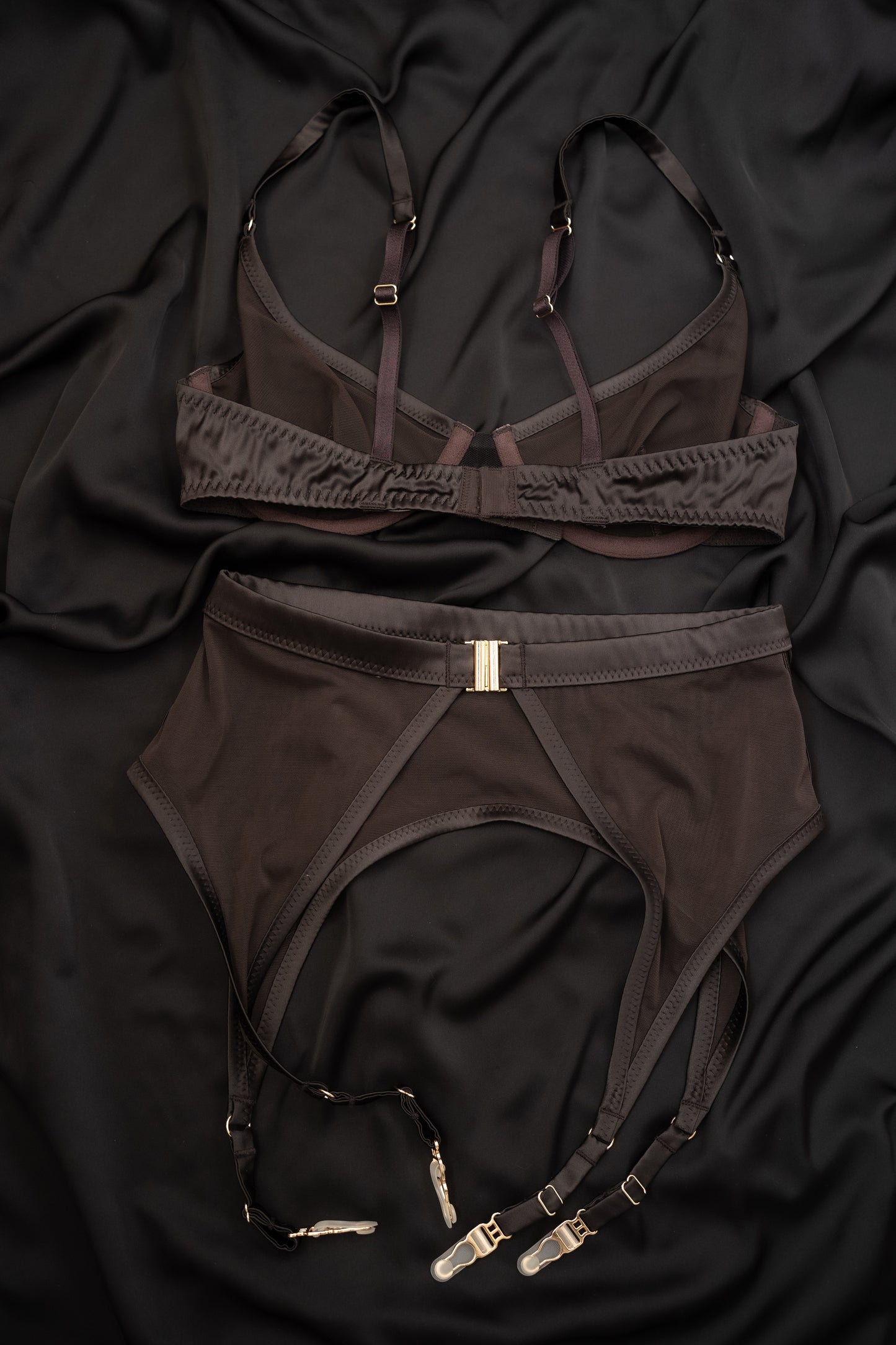 Brown lingerie Tate Chocolate set with garters on a black fabric background